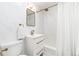 Bright bathroom with marble tile, modern vanity, and a shower-tub combination with a white curtain at 1065 S Monroe St, Denver, CO 80209