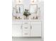 Elegant bathroom featuring double vanities, marble countertops, and stylish gold fixtures at 1065 S Monroe St, Denver, CO 80209