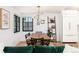 Dining room features a large table, stylish lighting, and an adjacent kitchen area at 1065 S Monroe St, Denver, CO 80209