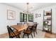 Bright dining room featuring a large wood table, modern lighting, and views of the backyard at 1065 S Monroe St, Denver, CO 80209