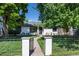 Charming home featuring a manicured front lawn and inviting walkway to the front door at 1065 S Monroe St, Denver, CO 80209