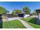 Detached garage with dark doors and professional landscaping adding charm to the home's exterior at 1065 S Monroe St, Denver, CO 80209
