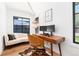Chic home office with hardwood floors, modern desk, and a comfortable seating area at 1065 S Monroe St, Denver, CO 80209
