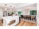 Modern open-concept kitchen features a large island, stainless steel appliances, and pendant lighting at 1065 S Monroe St, Denver, CO 80209