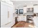 Modern kitchen with stainless steel appliances, quartz countertops, and hardwood floors at 1065 S Monroe St, Denver, CO 80209
