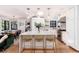 Modern kitchen features a large island, bar seating, and stainless steel appliances at 1065 S Monroe St, Denver, CO 80209