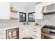 Updated kitchen featuring quartz countertops, stainless steel appliances, and modern fixtures at 1065 S Monroe St, Denver, CO 80209