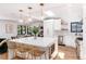 Open kitchen with island, stainless steel appliances, and bar seating, perfect for entertaining at 1065 S Monroe St, Denver, CO 80209