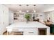 Open concept kitchen featuring a large island, quartz countertops and stainless steel appliances at 1065 S Monroe St, Denver, CO 80209
