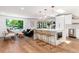 Spacious living room featuring an open layout, island seating, and large windows with natural light at 1065 S Monroe St, Denver, CO 80209