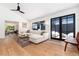 Open-concept living area with hardwood floors, sleek lighting, and large windows overlooking a patio at 1065 S Monroe St, Denver, CO 80209