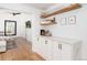 Bright and airy living room features stylish built-ins, hardwood floors, and modern decor at 1065 S Monroe St, Denver, CO 80209