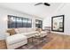 Bright living area with large windows, hardwood flooring, and elegant chandelier at 1065 S Monroe St, Denver, CO 80209