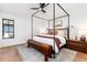 Spacious main bedroom featuring a four-poster bed frame and natural light at 1065 S Monroe St, Denver, CO 80209