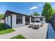 Brick paved patio, black trim windows and doors enhance the outdoor living and backyard aesthetic at 1065 S Monroe St, Denver, CO 80209