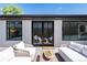Elegant patio with modern furniture and French doors, seamlessly blending indoor-outdoor living spaces at 1065 S Monroe St, Denver, CO 80209