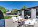 Inviting patio with brick pavers, white furniture and manicured backyard offer a perfect outdoor retreat at 1065 S Monroe St, Denver, CO 80209
