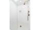 Modern walk-in shower with a glass door, white marble tile, and bronze shower fixtures at 1065 S Monroe St, Denver, CO 80209
