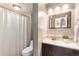 Clean bathroom with a modern vanity, tiled backsplash, and shower with curtain at 555 E 10Th Ave # 111, Denver, CO 80203
