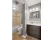 Bathroom features a shower and bath combination, along with vanity and modern mirror at 555 E 10Th Ave # 111, Denver, CO 80203