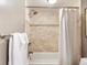 Bathroom with tile surround and a shower and tub combination at 555 E 10Th Ave # 111, Denver, CO 80203