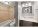 Bathroom features a shower and bath combination, along with vanity and modern mirror at 555 E 10Th Ave # 111, Denver, CO 80203