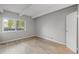 Bedroom features a large window, wood floors and closet at 555 E 10Th Ave # 111, Denver, CO 80203