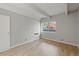 Bedroom features a large window, wood floors and closet at 555 E 10Th Ave # 111, Denver, CO 80203