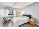 Cozy bedroom with a comfortable bed, wood floors, a nightstand, and a window bringing in lots of natural light at 555 E 10Th Ave # 111, Denver, CO 80203