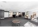 Expansive common room offering multiple seating areas, fireplace, and spiral staircase at 555 E 10Th Ave # 111, Denver, CO 80203