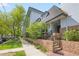 Charming building exterior with brick accents, manicured landscaping and inviting entrance at 555 E 10Th Ave # 111, Denver, CO 80203