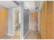 Hallway with wood floors features closet space and entry to bathroom at 555 E 10Th Ave # 111, Denver, CO 80203