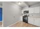 Efficient kitchen featuring white cabinets, modern appliances and bright natural light at 555 E 10Th Ave # 111, Denver, CO 80203