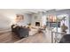 Bright living room with fireplace, hardwood floors, stylish furniture, and access to a balcony with city views at 555 E 10Th Ave # 111, Denver, CO 80203