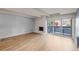 Bright and airy living room with wood floors, a fireplace, and sliding doors to a balcony at 555 E 10Th Ave # 111, Denver, CO 80203