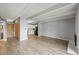 Spacious living room featuring wood floors, white ceiling beams and easy access to the kitchen at 555 E 10Th Ave # 111, Denver, CO 80203