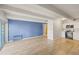 Open-concept living area with wood floors, natural light, and an adjacent modern kitchen at 555 E 10Th Ave # 111, Denver, CO 80203