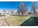 Large backyard with expansive lawn, and mature trees, perfect for outdoor activities and gatherings at 377 Stuart St, Denver, CO 80219