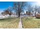 Spacious backyard features a vast grassy area, mature trees, and a serene setting for relaxation and recreation at 377 Stuart St, Denver, CO 80219