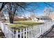 Spacious backyard with green grass, bordered by a white picket fence and a wooden fence at 377 Stuart St, Denver, CO 80219