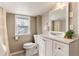 Cozy bathroom featuring a modern vanity, decorative window, and neutral color palette at 377 Stuart St, Denver, CO 80219