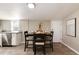 Charming dining area with sleek, dark table and stainless steel appliances nearby at 377 Stuart St, Denver, CO 80219