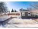 Home featuring a white picket fence and covered entryway at 377 Stuart St, Denver, CO 80219