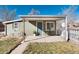 Quaint covered front porch with a table and chairs, perfect for relaxing outdoors at 377 Stuart St, Denver, CO 80219