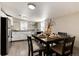 Bright kitchen featuring modern appliances, white cabinets, and stylish dining area at 377 Stuart St, Denver, CO 80219