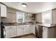 Bright kitchen with white cabinets, granite countertops, and modern stainless steel dishwasher at 377 Stuart St, Denver, CO 80219