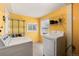 Bright laundry room with washer, dryer, ample shelving, and natural light at 377 Stuart St, Denver, CO 80219