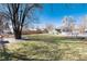 Expansive backyard features a lush lawn, mature trees, and privacy fencing for outdoor enjoyment and relaxation at 377 Stuart St, Denver, CO 80219