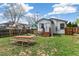 Backyard featuring grass, shed, swing set, picnic table, and newly stained deck at 2896 Depew St, Wheat Ridge, CO 80214