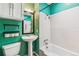 Bathroom with white tile bathtub, colorful walls, and vanity sink at 2896 Depew St, Wheat Ridge, CO 80214